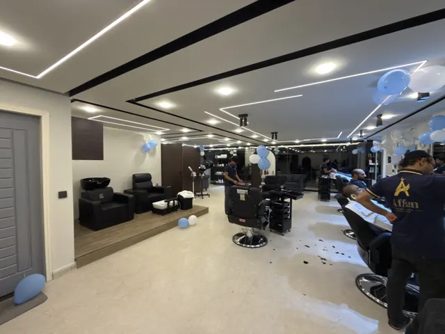The hall: lines of light on the ceiling and a row of barber chairs