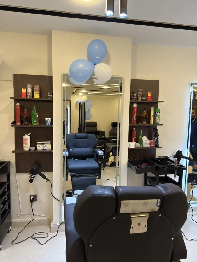 A barber station: chair, mirror and shelves of products
